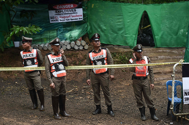 thai police stand guard at the tham luang cave area as operations continue for the 12 boys and their coach trapped at the cave in khun nam nang non forest park in the mae sai district photo afp thai police stand guard at the tham luang cave area as operations continue for the 12 boys and their coach trapped at the cave in khun nam nang non forest park in the mae sai district photo afp