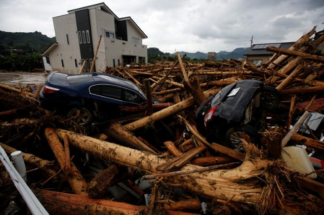 torrential rains that saw some parts of western japan pounded with three times the usual precipitation for a normal july set off landslides and sent rivers surging over their banks trapping many people in their houses or on rooftops photo reuters