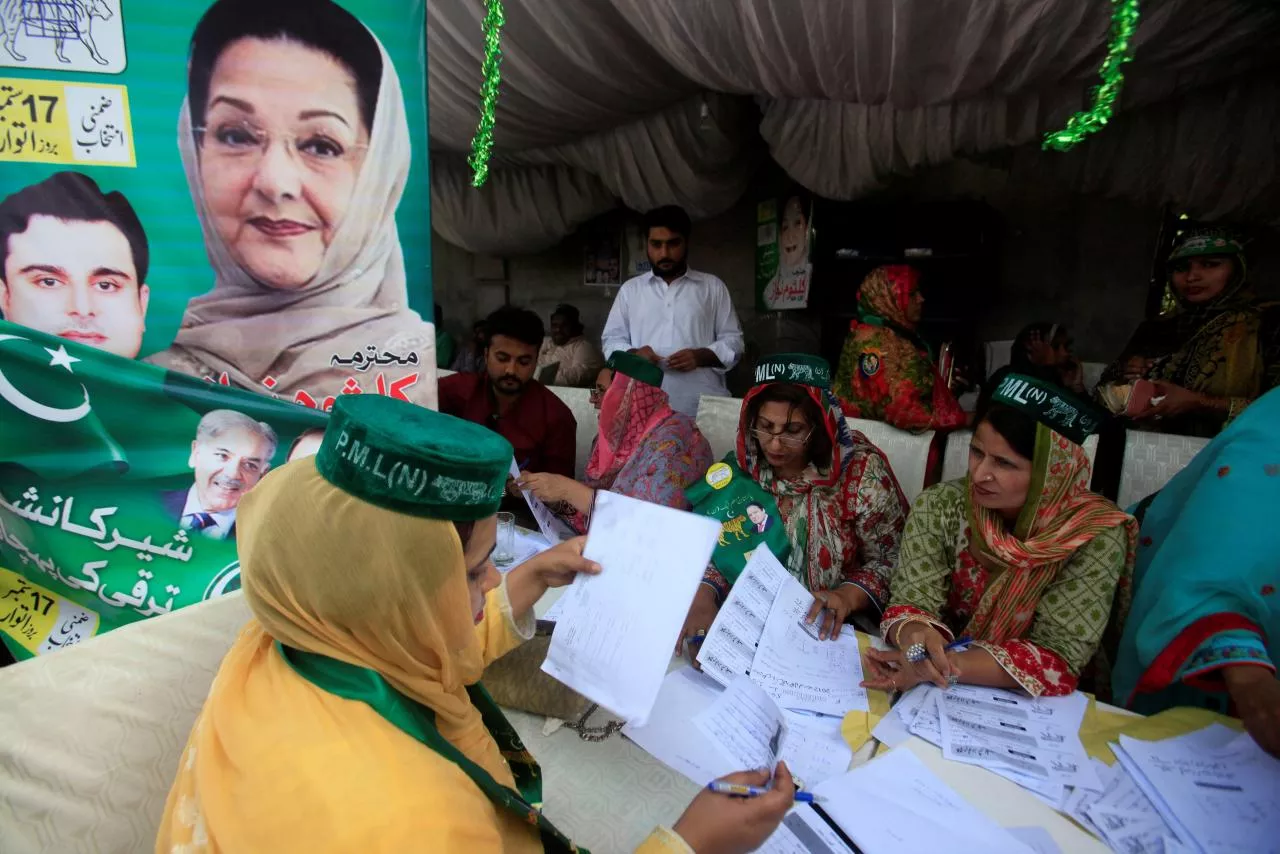 workers of the pmln political party guide voters and share voting lists outside a polling station in lahore pakistan september 17 2017 photo reuters workers of the pmln political party guide voters and share voting lists outside a polling station in lahore pakistan september 17 2017 photo reuters