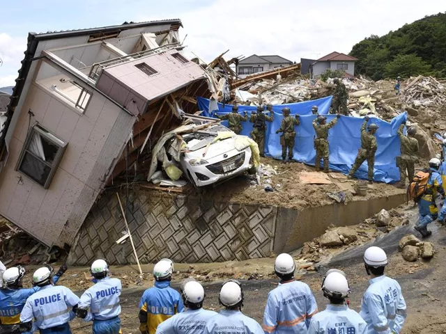 rescue workers look for missing people in a house damaged by heavy rain in kumano town hiroshima prefecture reuters rescue workers look for missing people in a house damaged by heavy rain in kumano town hiroshima prefecture reuters