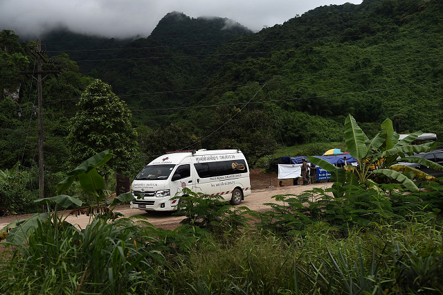 an ambulance exits from the tham luang cave area as operations continue for the eight boys and their coach still trapped at the cave in khun nam nang non forest park in the mae sai district photo afp