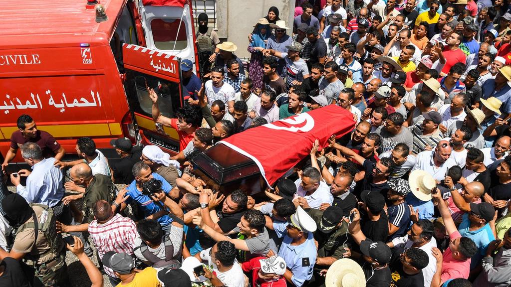 mourners carry the coffin of killed sgt arbi guizani one of six security tunisian officers killed on sunday at his funeral in tunis on july 9 2018 photo afp