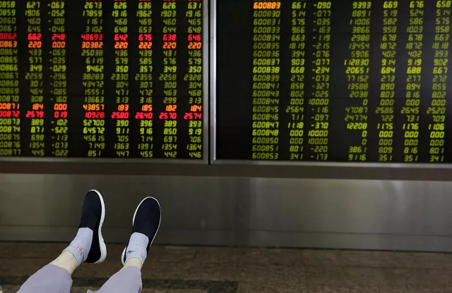 the feet of an investor are pictured as he looks at a board showing stock prices at a brokerage office in beijing china july 6 2018 photo reuters the feet of an investor are pictured as he looks at a board showing stock prices at a brokerage office in beijing china july 6 2018 photo reuters