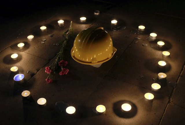 a mining helmet and carnations are seen placed on the ground by demonstrators during a candlelight vigil for the victims of the soma mining disaster in western turkey in istanbul may 18 2014 photo reuters