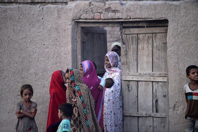 pakistani villager women gather outside their home in mohri pur village where women had previously been banned from voting photo afp