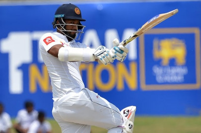 defiant karunaratne carries bat for sri lanka with 158