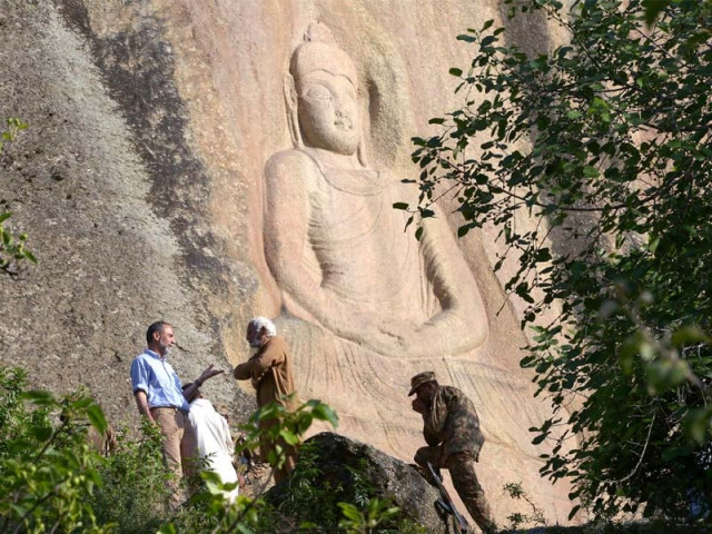 italian archaeologist luca maria olivieri speaking with pakistani historian parvesh shaheen next to the seventh century rock sculpture of a seated buddha in swat photo afp italian archaeologist luca maria olivieri speaking with pakistani historian parvesh shaheen next to the seventh century rock sculpture of a seated buddha in swat photo afp
