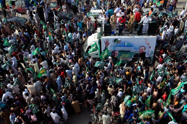 supporters of the pakistan muslim league   nawaz pml n chant and march towards the airport to welcome ousted prime minister nawaz sharif and his daughter maryam in lahore photo reuters