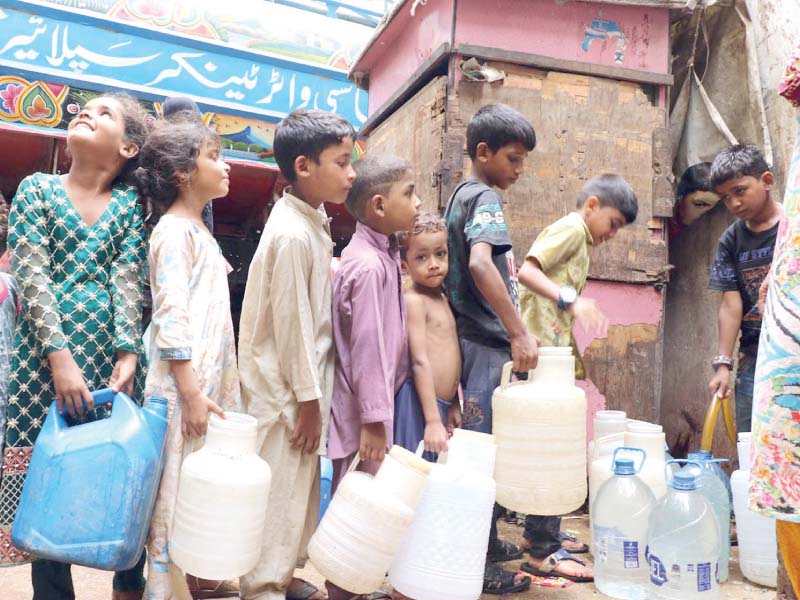 children stand in queue to fill their bottles with potable water from a tanker in the metropolis photo online