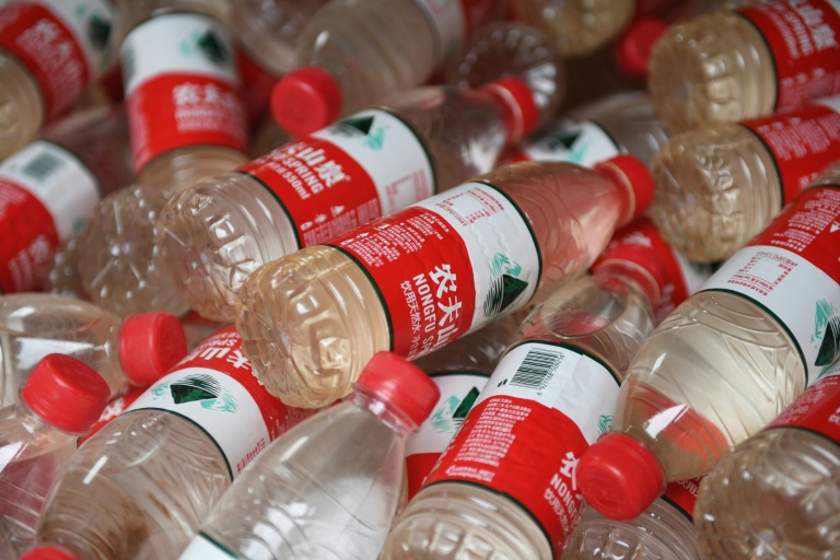 a travelling exhibition displays water bottles filled with contaminated water photo afp