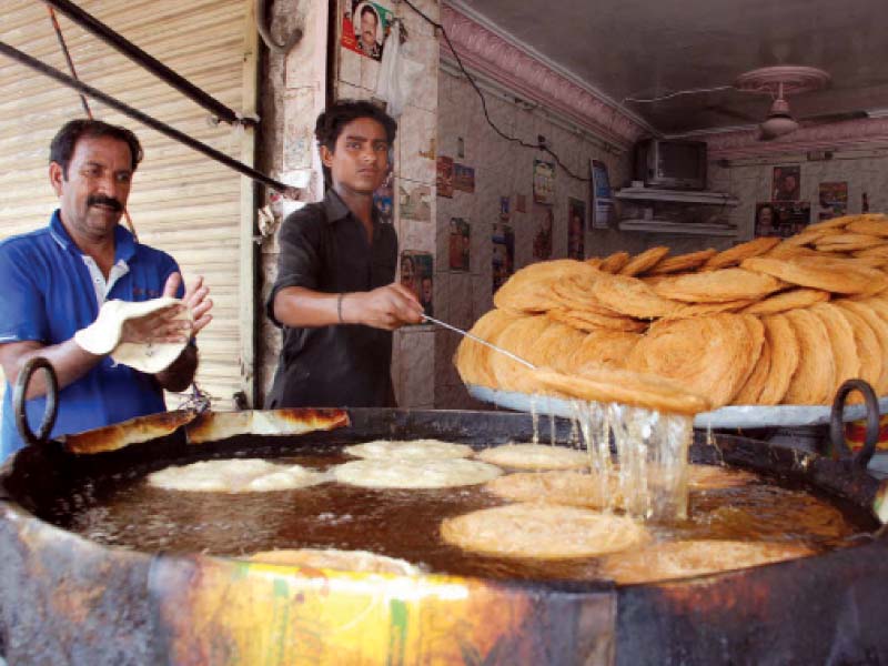 vendors preparing traditional delicacy phainian at a stall in rawalpindi on thursday photo inp