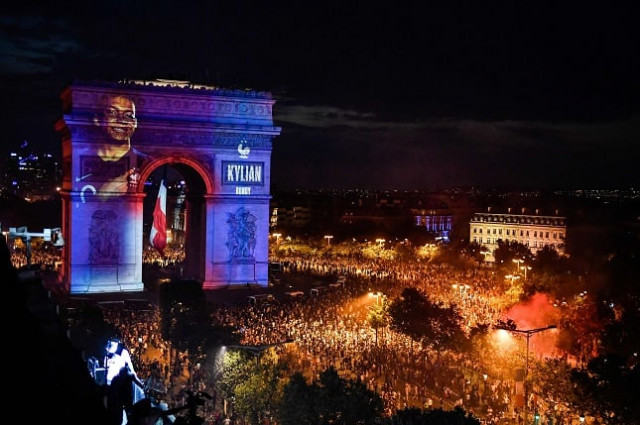 this picture taken from the terrace of the publicis drugstore on july 15 2018 shows a portrait of french forward kylian mbappe projected on paris 039 landmark arc de triomphe as people gather to celebrate france 039 s victory in the russia 2018 world cup final football match between france and croatia on the champs elysees avenue in paris photo afp this picture taken from the terrace of the publicis drugstore on july 15 2018 shows a portrait of french forward kylian mbappe projected on paris 039 landmark arc de triomphe as people gather to celebrate france 039 s victory in the russia 2018 world cup final football match between france and croatia on the champs elysees avenue in paris photo afp