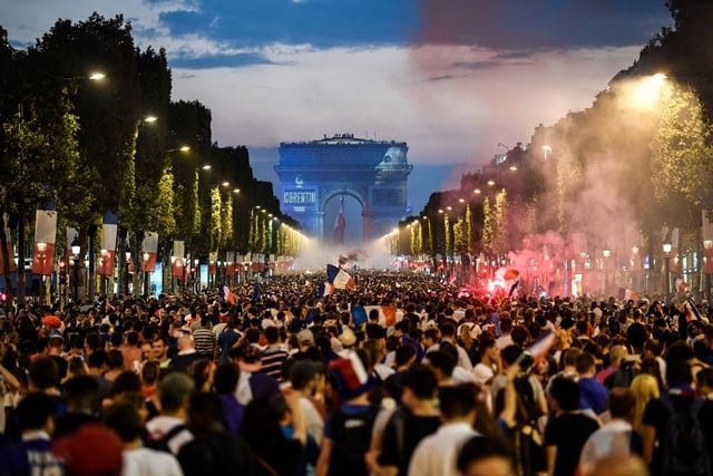 people celebrate france 039 s victory in the russia 2018 world cup final football match between france and croatia on the champs elysees avenue in paris on july 15 2018 photo afp