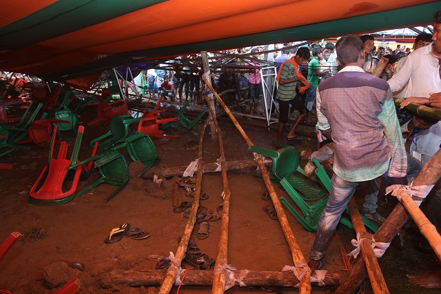 supporters of bhartiya janta party look inside a damaged tent which collapsed during a public meeting addressed by prime minister narendra modi at a college ground in midnapore on july 16 2018 photo afp