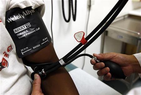 a doctor checks the blood pressure of a patient photo reuters