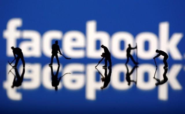 figurines are seen in front of the facebook logo in this illustration taken march 20 2018 photo reuters