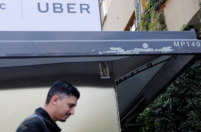 a man walks by under an uber logo in mexico city mexico february 6 2018 photo reuters a man walks by under an uber logo in mexico city mexico february 6 2018 photo reuters