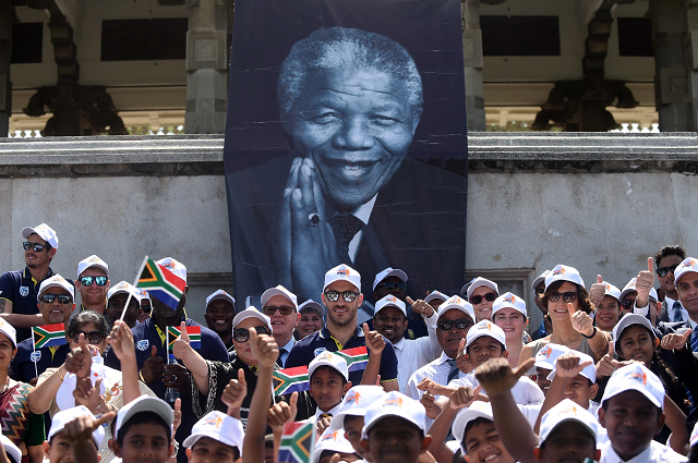 south african cricket team captain faf du plessis poses with school children and teammates at a ceremony to mark the 100th birth anniversary of south african anti apartheid revolutionary and statesman nelson mandela photo afp