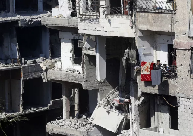 syrian children stand on a balcony of a destroyed building in harasta on the outskirts of the syrian capital damascus photo afp syrian children stand on a balcony of a destroyed building in harasta on the outskirts of the syrian capital damascus photo afp