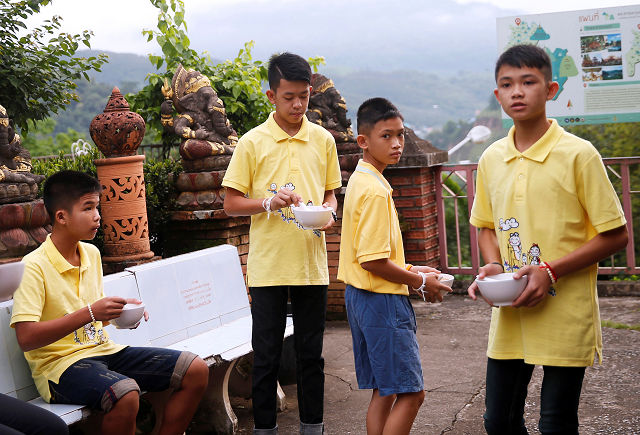 members of the soccer team rescued from a cave eat their breakfast during a religious ceremony photo reuters members of the soccer team rescued from a cave eat their breakfast during a religious ceremony photo reuters