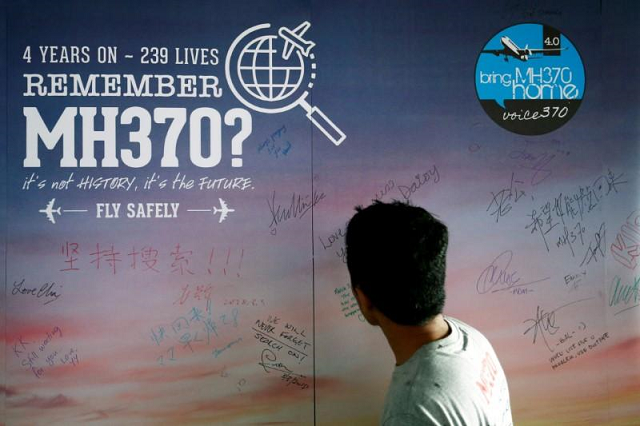 a man looks at a message board for passengers onboard the missing malaysia airlines flight mh370 during its fourth annual remembrance event in kuala lumpur malaysia march 3 2018 photo reuters