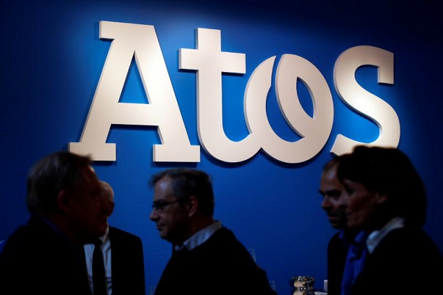 people walk in front of atos company 039 s logo during a presentation of the new bull sequana supercomputer in paris france april 12 2016 photo reuters