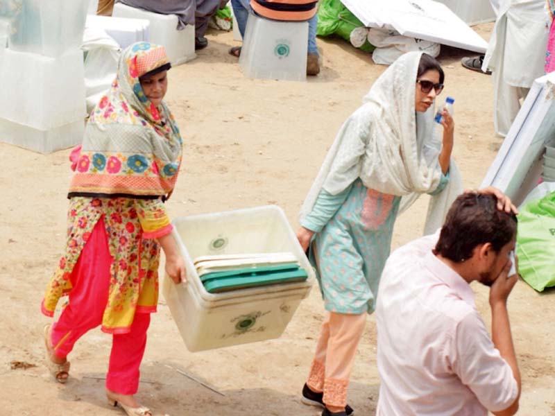 two female presiding officers carry a ballot box to a polling station in the provincial capital photo nni online