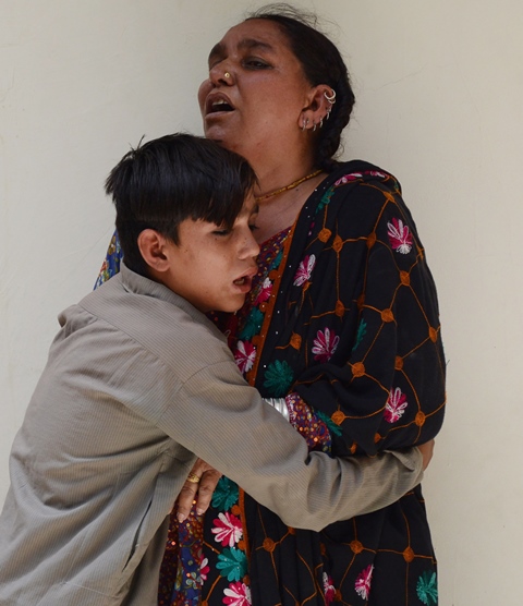 a pakistani woman and her son react after her husband was injured in a suicide attack in quetta photo afp