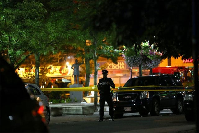 a police officer stands guard at the scene of a mass shooting in toronto canada july 22 2018 photo reuters a police officer stands guard at the scene of a mass shooting in toronto canada july 22 2018 photo reuters