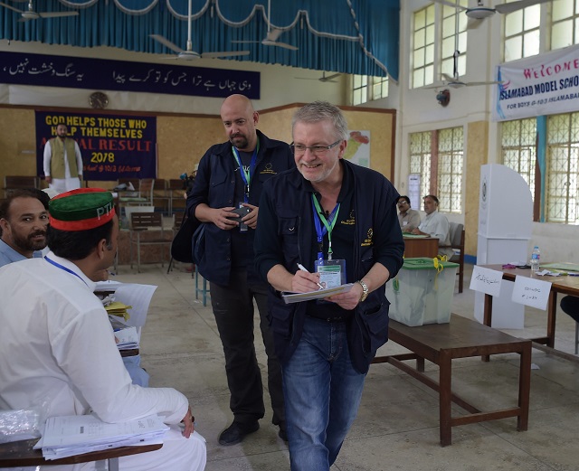 european union election observer officials speak to political parties agents at a polling station during pakistan 039 s general election in islamabad on july 25 2018 photo afp