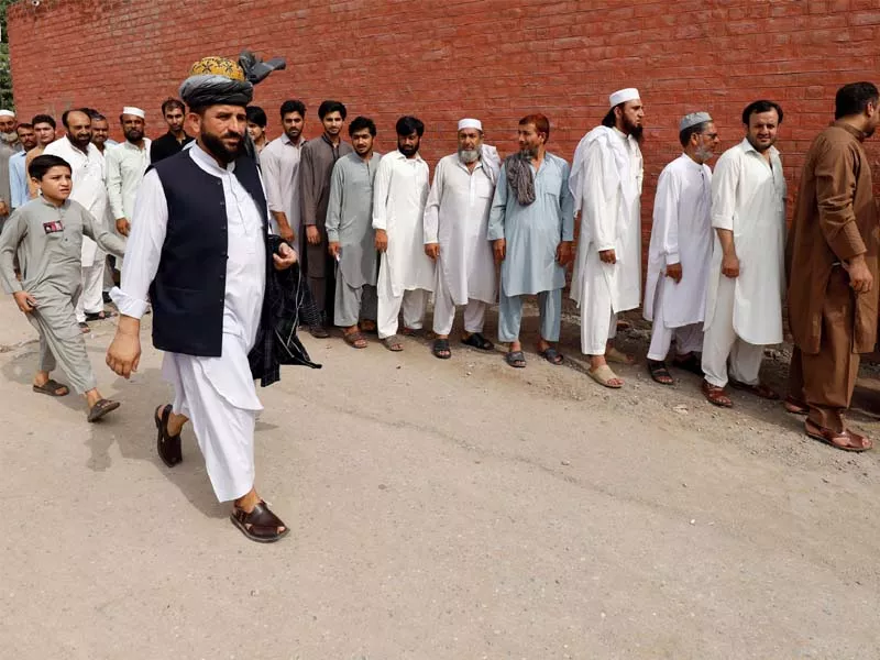 men stand in line to cast their vote outside a polling station in peshawar photo reuters men stand in line to cast their vote outside a polling station in peshawar photo reuters