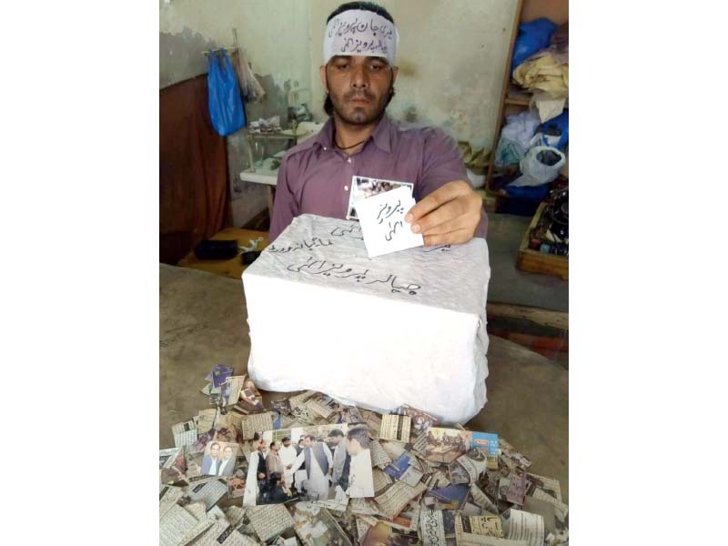 khalid pervez a victim of paralysis cast his vote into a wooden ballot box photo express