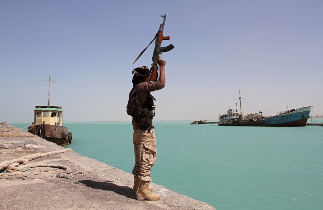 in this file photo taken on february 08 2017 a member of the pro government forces raises his weapon in the port of the western yemeni coastal town of mokha as the saudi backed troops advance in a bid to try to drive the huthi rebels away photo afp file