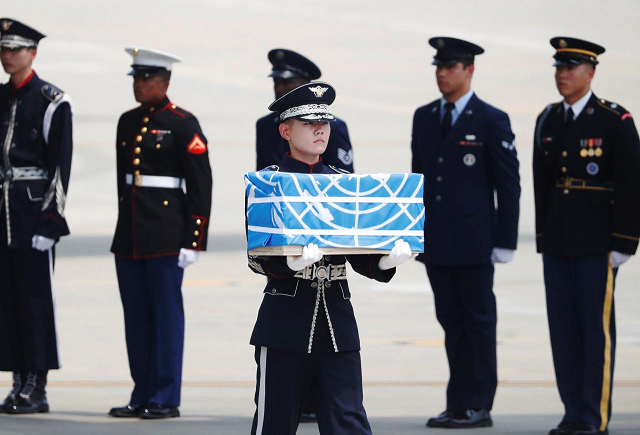 a soldier carries a casket containing the remains of a u s soldier who was killed in the korean war during a ceremony at osan air base in pyeongtaek south korea july 27 2018 photo reuters