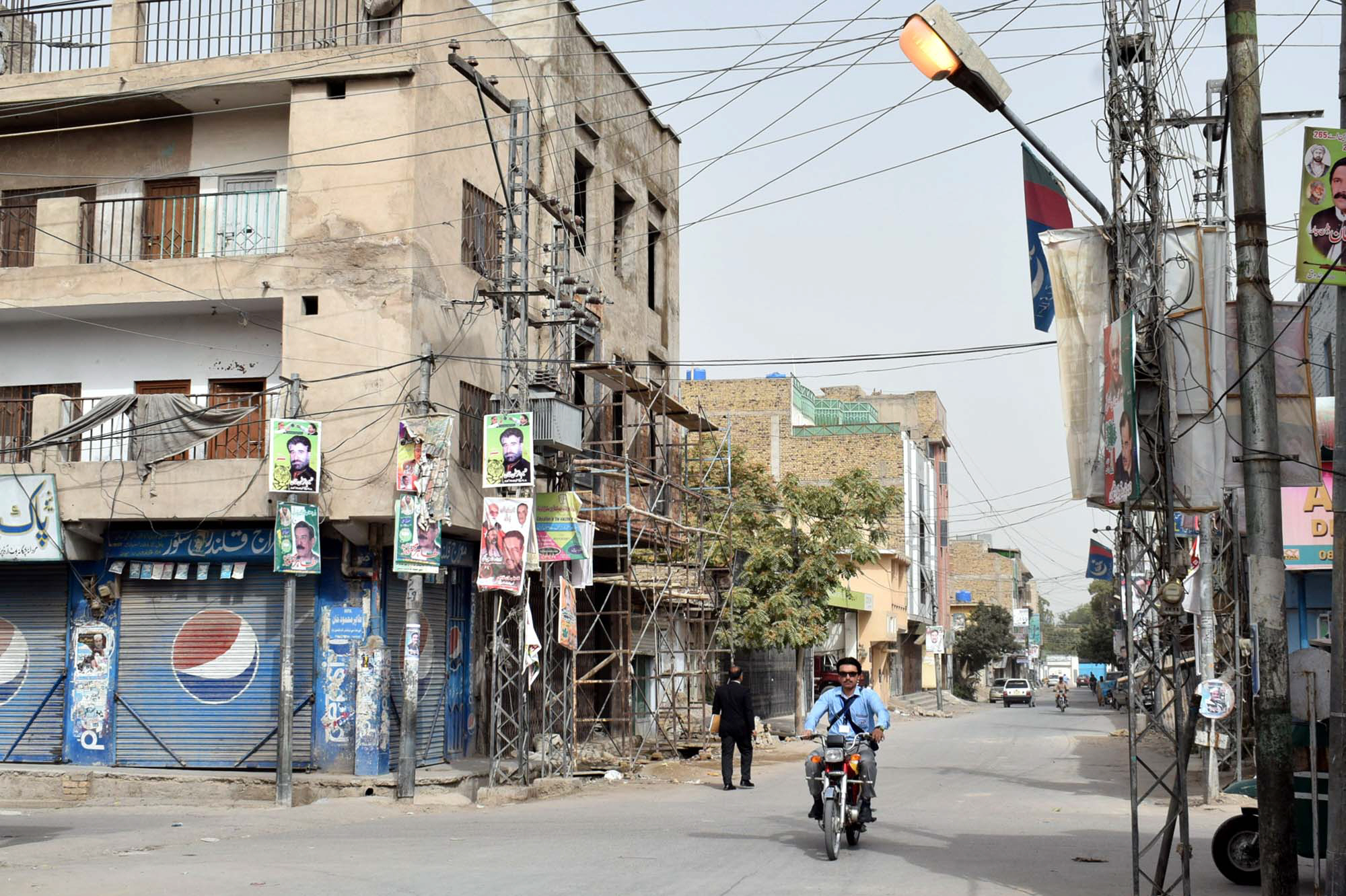 a street light is left on during daytime while the city faces severe power shortage photo express