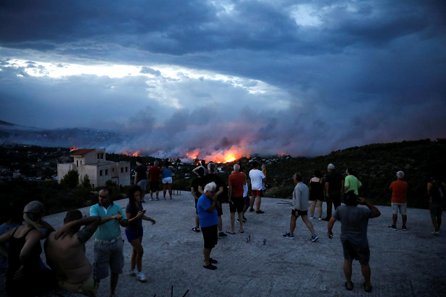 people watch a wildfire raging in the town of rafina near athens greece july 23 2018 photo reuters