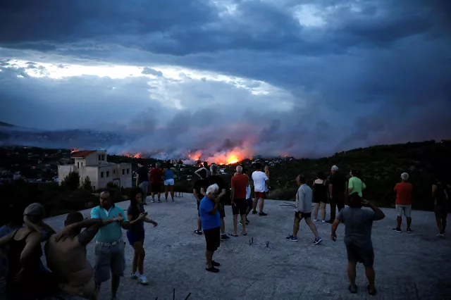 people watch a wildfire raging in the town of rafina near athens greece july 23 2018 photo reuters people watch a wildfire raging in the town of rafina near athens greece july 23 2018 photo reuters