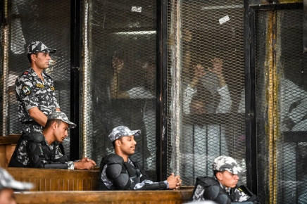 members of egypt 039 s banned muslim brotherhood are seen inside a glass dock during their trial in the capital cairo on july 28 2018 photo reuters
