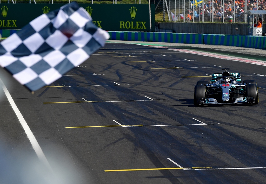 top of the pile mercedes 039 british driver lewis hamilton crosses the finish line to win the formula one hungarian grand prix at the hungaroring circuit photo afp