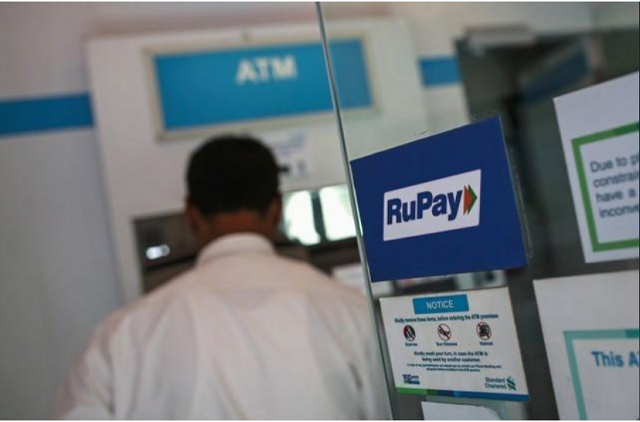 a rupay sign is seen on the door of an automated teller machine atm while a user is seen at a commercial building in mumbai september 11 2014 photo reuters a rupay sign is seen on the door of an automated teller machine atm while a user is seen at a commercial building in mumbai september 11 2014 photo reuters