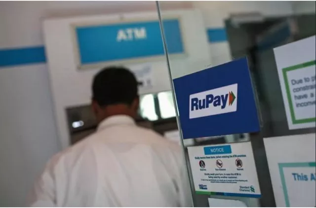 a rupay sign is seen on the door of an automated teller machine atm while a user is seen at a commercial building in mumbai september 11 2014 photo reuters a rupay sign is seen on the door of an automated teller machine atm while a user is seen at a commercial building in mumbai september 11 2014 photo reuters