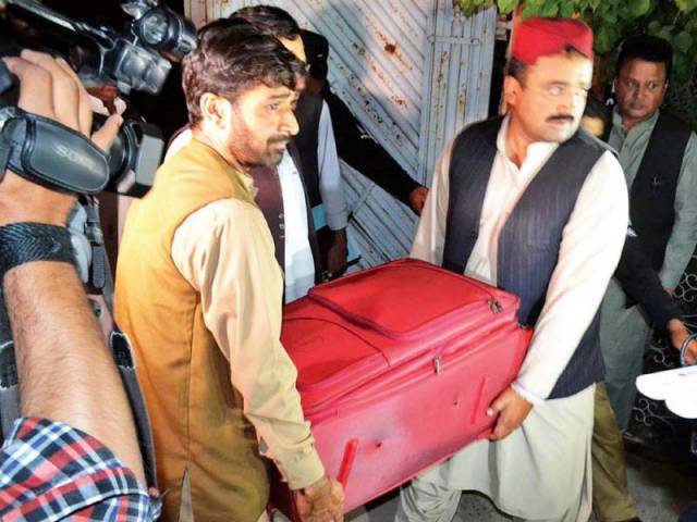 in this picture taken in may 2016 officers are seen taking away one of the suitcases full of cash found at the house of mushtaq raisani photo online