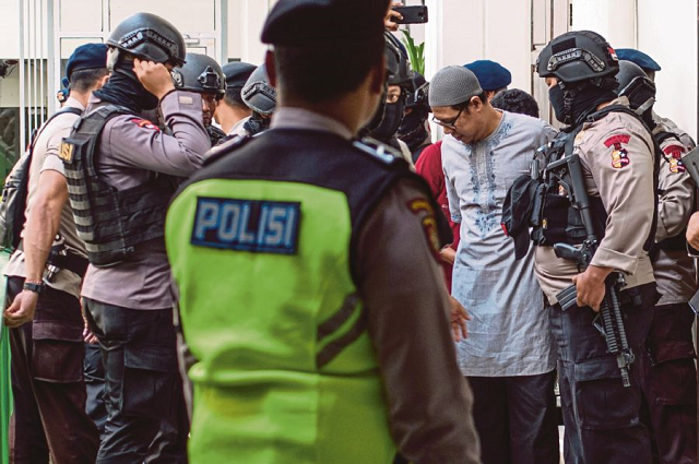 jemaah ansharut daulah leader being escorted by police photo afp jemaah ansharut daulah leader being escorted by police photo afp