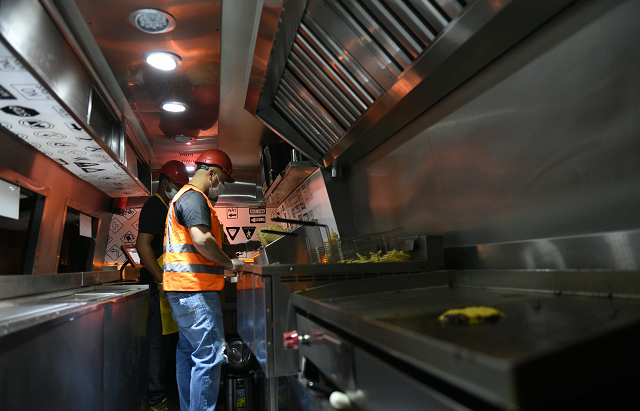 bader al ajmi 38 owner of one way burger cooking food at his truck at a main street in the capital riyadh photo afp