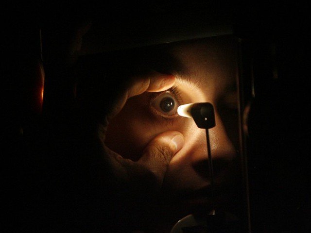 a doctor checks the eye of a patient photo reuters file