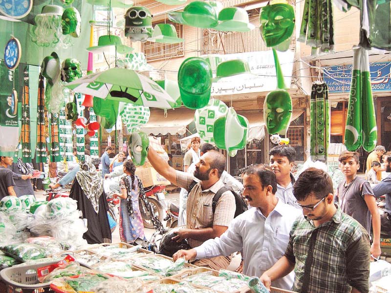 people buy independence day related stuff from a roadside stall in the provincial capital photo inp