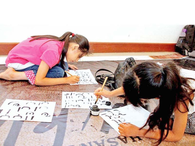 children practice writing with wooden pens at a calligraphy workshop organized by pnca photo inp children practice writing with wooden pens at a calligraphy workshop organized by pnca photo inp