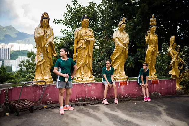 in this photo taken on august 2 2018 syrian teammates of squash dreamers a us ngo based in jordan l to r eman hassan 12 raghda husryeh 13 and her sister sabah husryeh 11 rest in the grounds of the 10 000 buddhas monastery in hong kong three young syrian squash players aged between 11 and 13 are part of a new team called squash dreamers made up of displaced syrian youngsters who were forced to flee their war torn homeland photo afp in this photo taken on august 2 2018 syrian teammates of squash dreamers a us ngo based in jordan l to r eman hassan 12 raghda husryeh 13 and her sister sabah husryeh 11 rest in the grounds of the 10 000 buddhas monastery in hong kong three young syrian squash players aged between 11 and 13 are part of a new team called squash dreamers made up of displaced syrian youngsters who were forced to flee their war torn homeland photo afp