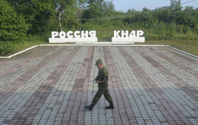 a guard walks along the platform at the border crossing between russia and north korea at the north korean settlement of tumangan july 18 2014 the signage reads quot russia quot and quot kndr democratic people 039 s republic of korea quot photo reuters