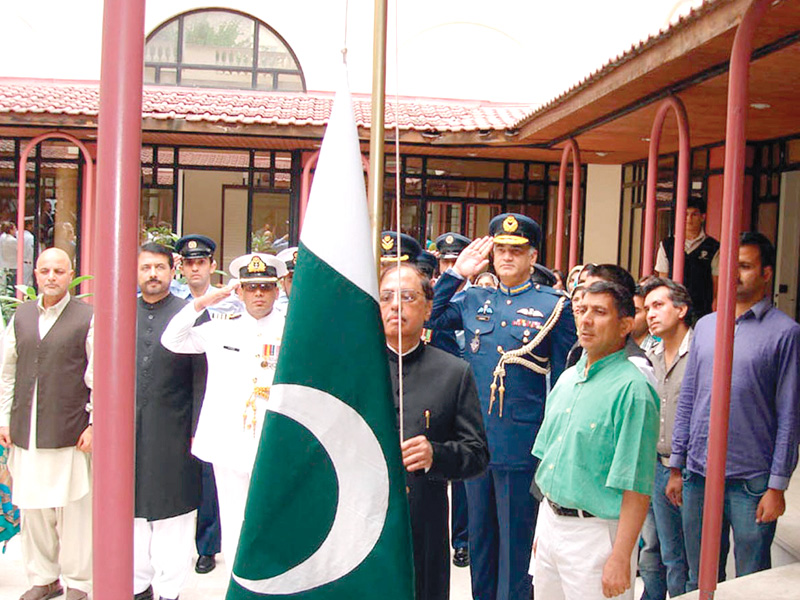 pakistan s ambassador to france shafkat saeed hoists the flag at the embassy in paris photo nni
